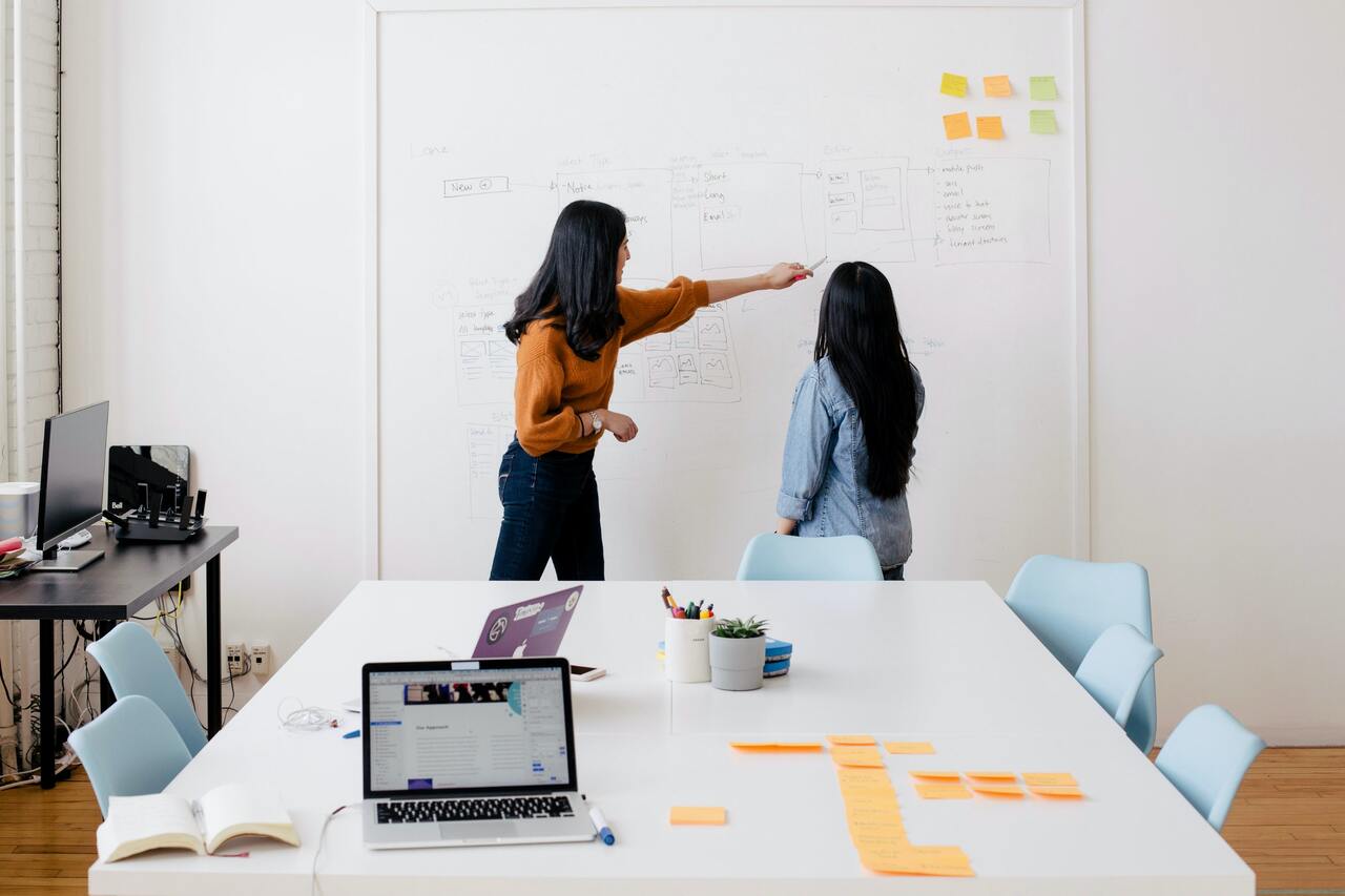 two ladies discussing in a meeting